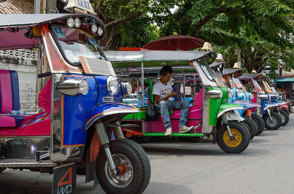 Tuk-tuks line up and wait for custom, Bangkok.