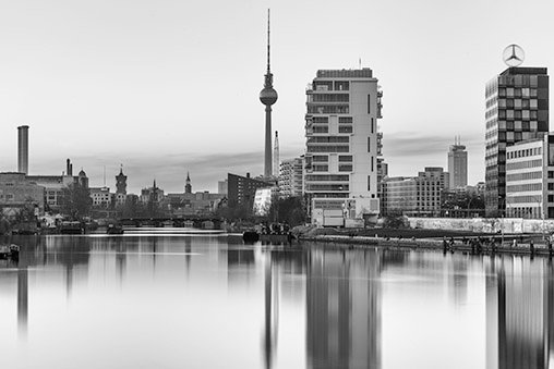 A long exposure shot of the Reichstag next the the river Spree.