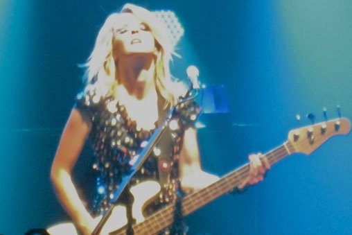 Charlotte from The Subways performing on stage.