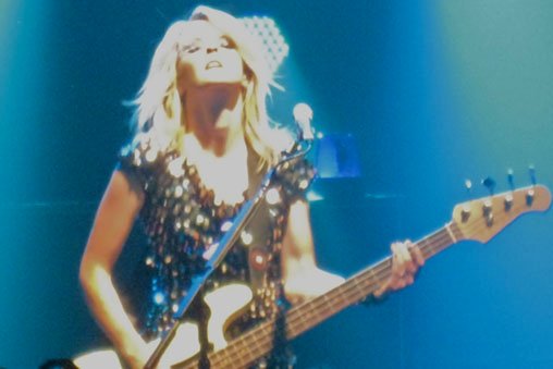 Charlotte from The Subways performing on stage.